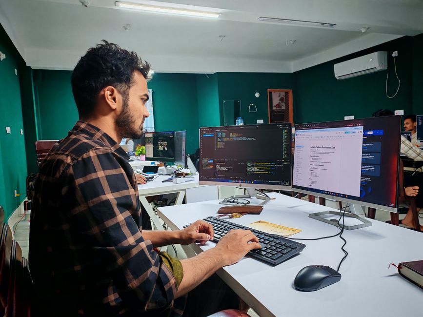 Developer working on dual monitor setup